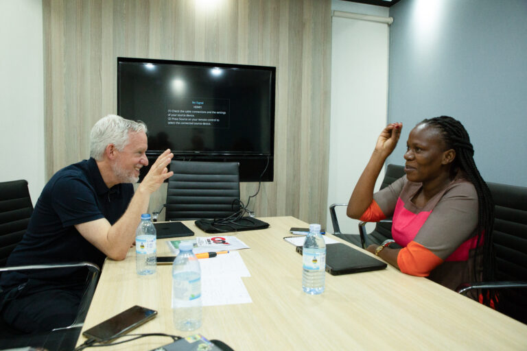 BPN Uganda business coaching session with coach and entrepreneur discussing strategies for growth and success.