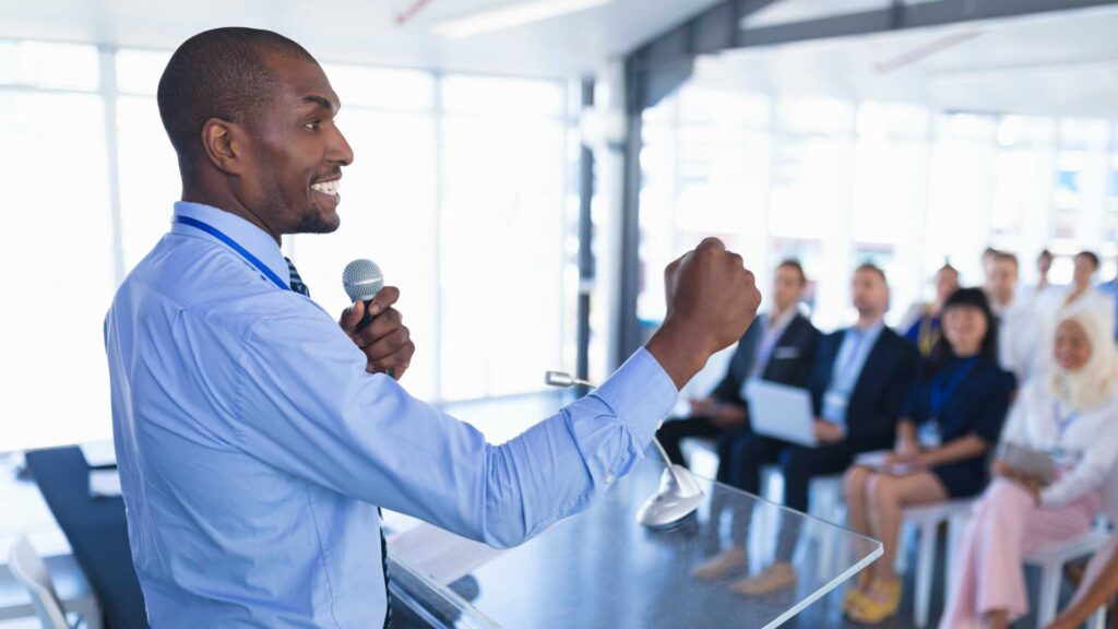 A professional photo of an entrepreneur speaking confidently to potential investors or clients, representing the importance of crafting a strong elevator pitch.