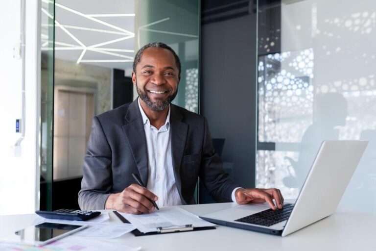 Entrepreneur reviewing documents and planning a marketing strategy at a desk